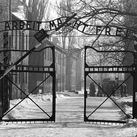 Gates of Auschwitz, with the German phrase Arbeit macht frei, meaning "Work sets you free" 