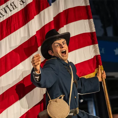 Arthur McArthur is depicted carrying the Union flag during the Battle of Missionary Ridge