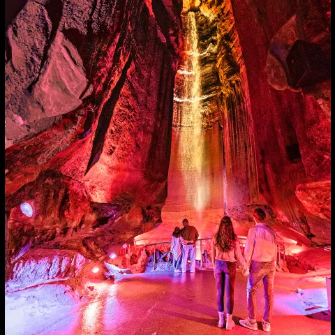 couple standing in front of an underground waterfall