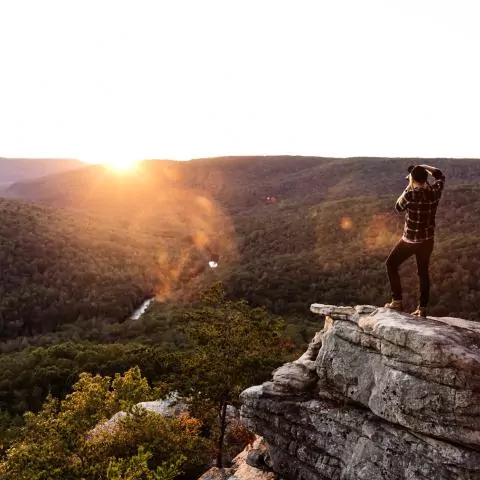 A traveler on top of Welch's Point Overlook during sunset in Sparta TN